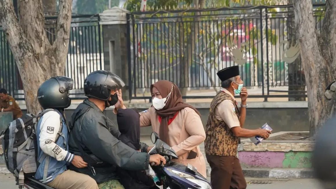 Plt Sekretaris DPRD Kota Jambi Bersama Kwarcab Pramuka Bagikan Masker untuk Warga di Tengah Kabut Asap